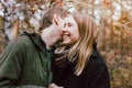 Happy young couple in love friends dressed in casual style walking together on autumn nature park forest, family advenure travel Royalty Free Stock Photo