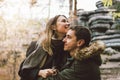 Happy young couple in love friends dressed in casual style walking together on nature park forest in cold season, family Royalty Free Stock Photo