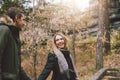 Happy young couple in love friends dressed in casual style walking together on nature park forest in cold season, family advenure Royalty Free Stock Photo