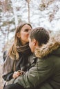 Happy young couple in love friends dressed in casual style walking together on nature park forest in cold season Royalty Free Stock Photo