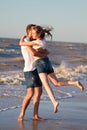 Happy young couple in love have fun on beautiful beach at beautiful summer day Royalty Free Stock Photo