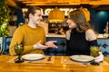 Happy young couple in love having a nice date in a bar or restaurant telling some stories about themself Royalty Free Stock Photo