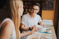 Happy young couple in love having a nice date in a bar or restaurant. They telling some stories about themself Royalty Free Stock Photo