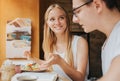 Happy young couple in love having a nice date in a bar or restaurant. They telling some stories about themself Royalty Free Stock Photo