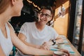 Happy young couple in love having a nice date in a bar or restaurant. They telling some stories about themself Royalty Free Stock Photo