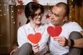 couple in love holding a red heart in their hands Royalty Free Stock Photo