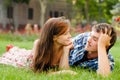 Happy young couple in love lying on green grass Royalty Free Stock Photo