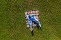 Happy young couple in love lying in the park together on blanket from above, Aerial view Royalty Free Stock Photo