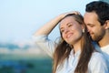 Happy young couple in love posing on summer sunset