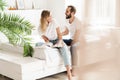 Happy young couple in love relaxing on a couch at the living room Royalty Free Stock Photo