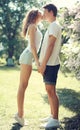 Happy young couple in love, sensual kiss at sunny warm spring
