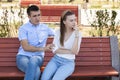 Happy young couple in love sitting on a park bench Royalty Free Stock Photo