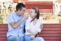 Happy young couple in love sitting on a park bench Royalty Free Stock Photo