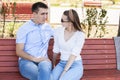 Happy young couple in love sitting on a park bench Royalty Free Stock Photo