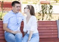 Happy young couple in love sitting on a park bench Royalty Free Stock Photo