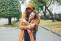 Happy young couple in love teenagers friends dressed in casual style sitting together on autumn city street Royalty Free Stock Photo