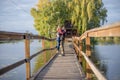 Happy young couple in love walking in bridge at sunset. Man embracing and going to kiss sensual woman Royalty Free Stock Photo