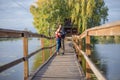 Happy young couple in love walking in bridge at sunset. Man embracing and going to kiss sensual woman Royalty Free Stock Photo