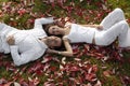 Happy young couple lying in autumn leaves
