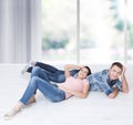 Happy young couple, lying on the floor, look at each other and dream of furniture for a new apartment. Mock up Royalty Free Stock Photo