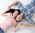 Happy young couple, lying on the floor, look at each other and dream of furniture for a new apartment. Mock up Royalty Free Stock Photo