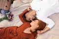 Happy young couple lying on picnic blanket Royalty Free Stock Photo