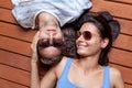 Happy young couple lying on a wooden floor Royalty Free Stock Photo