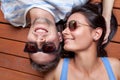 Happy young couple lying on a wooden floor Royalty Free Stock Photo