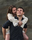 Happy young couple. Man piggybacking his girlfriend in summer Royalty Free Stock Photo