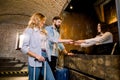 Happy young couple, man and woman, standing at stylish hotel reception, checking in upon arrival, smiling. Royalty Free Stock Photo