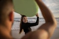 Happy Young Couple Man And Woman Surfing On The Beach Royalty Free Stock Photo