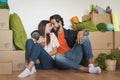 Happy young couple moving in new home first time - Man and woman having fun unpacking carton box in new property house Royalty Free Stock Photo