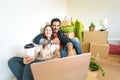 Happy young couple moving in new home first time - Man and woman having fun using computer next carton box in new property house Royalty Free Stock Photo