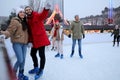 Happy young couple near fence at outdoor ice rink Royalty Free Stock Photo