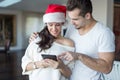 Happy young couple online shopping for Christmas on tablet at home Royalty Free Stock Photo