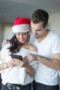 Happy young couple online shopping for Christmas on tablet at home Royalty Free Stock Photo