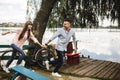 Happy young couple outdoors. young love couple running along a wooden bridge holding hands Royalty Free Stock Photo