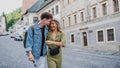 Happy young couple outdoors on street on town trip, walking and talking. Royalty Free Stock Photo