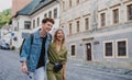 Happy young couple outdoors on street on town trip, walking and talking. Royalty Free Stock Photo