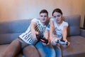 Happy young couple are so passionated about the process of a game Royalty Free Stock Photo