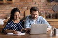 Happy young couple paying utility bill, taxes, insurance, mortgage Royalty Free Stock Photo