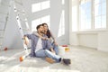 Happy young couple planning home repair while sitting on floor in living room Royalty Free Stock Photo