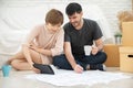 Happy young couple planning their new moving house. Royalty Free Stock Photo