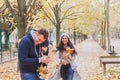 Happy young couple playing outside in autumn park