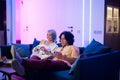 Happy young couple playing a video game sitting at home on a sofa during self isolation on quarantine. Royalty Free Stock Photo