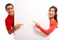 Happy young couple pointing to copy space Royalty Free Stock Photo