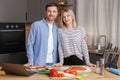 Happy young couple is preparing healthy and tasty food on modern kitchen. Healthy food concept Royalty Free Stock Photo