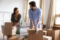 Happy young couple preparing to moving day, packing cardboard boxes Royalty Free Stock Photo