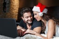 Happy young couple purchasing online christmas gift Royalty Free Stock Photo