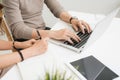 Happy young couple reading and analyzing bills sitting at table. Royalty Free Stock Photo